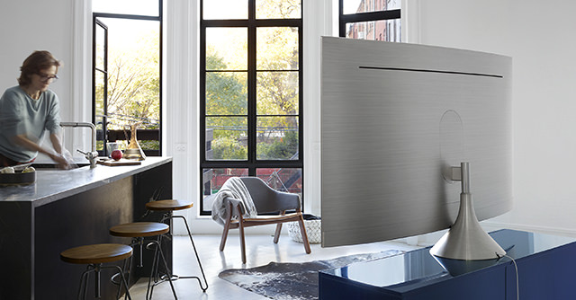 그래비티 스탠드가 장착된 제품의 뒷면이 보여지고 제품의 앞쪽에는 바 테이블에서 손을 닦고 있는 여성의 모습이 보여지고 있습니다.