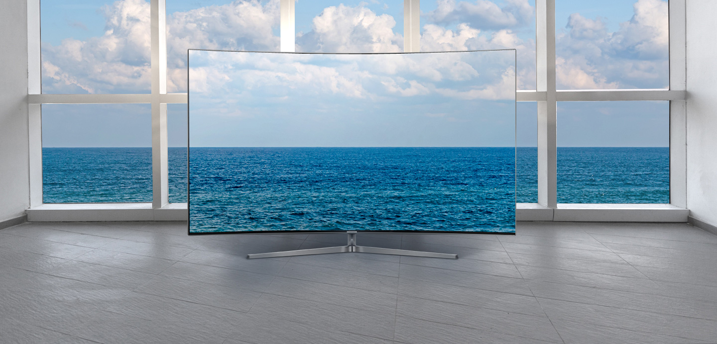 Boundless screen of Samsung TV is standing in front of large window - day time view.